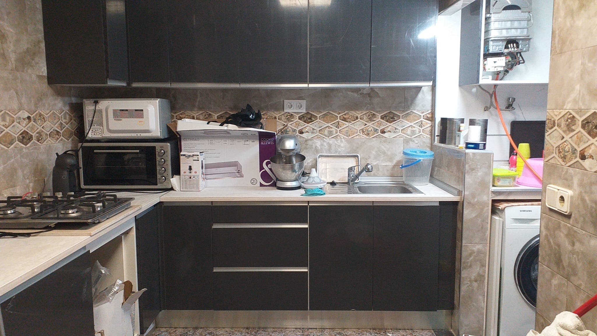 Kitchen being fitted with new, still-unboxed appliances